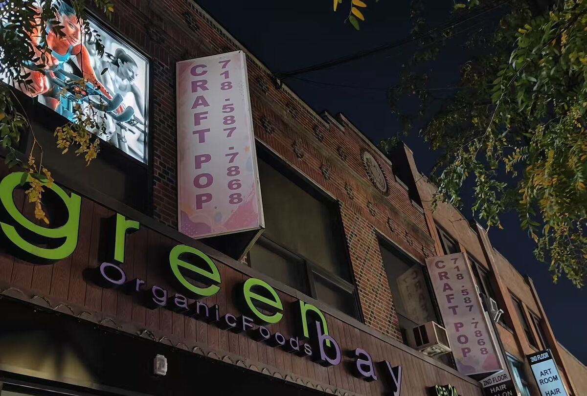 Craft Pop vertical sign above Green Bay Organic Foods on 30th Avenue in Astoria at night