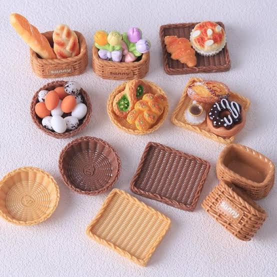 Miniature clay bread, croissants and pastries in tiny woven baskets