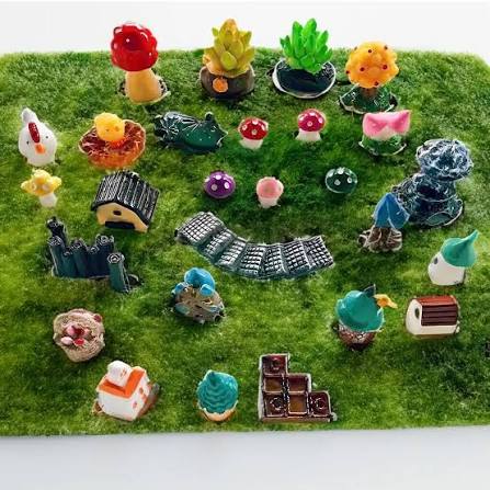 Miniature moss landscape with tiny houses, mushrooms, a path and little animals
