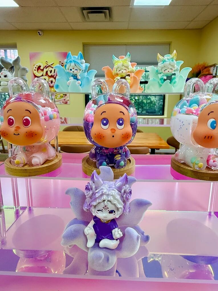 Painted character figures under clear domes and a lavender fairy figure