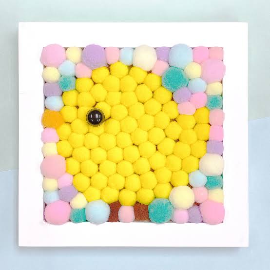 Yellow chick picture made from colorful pom-poms in a white frame